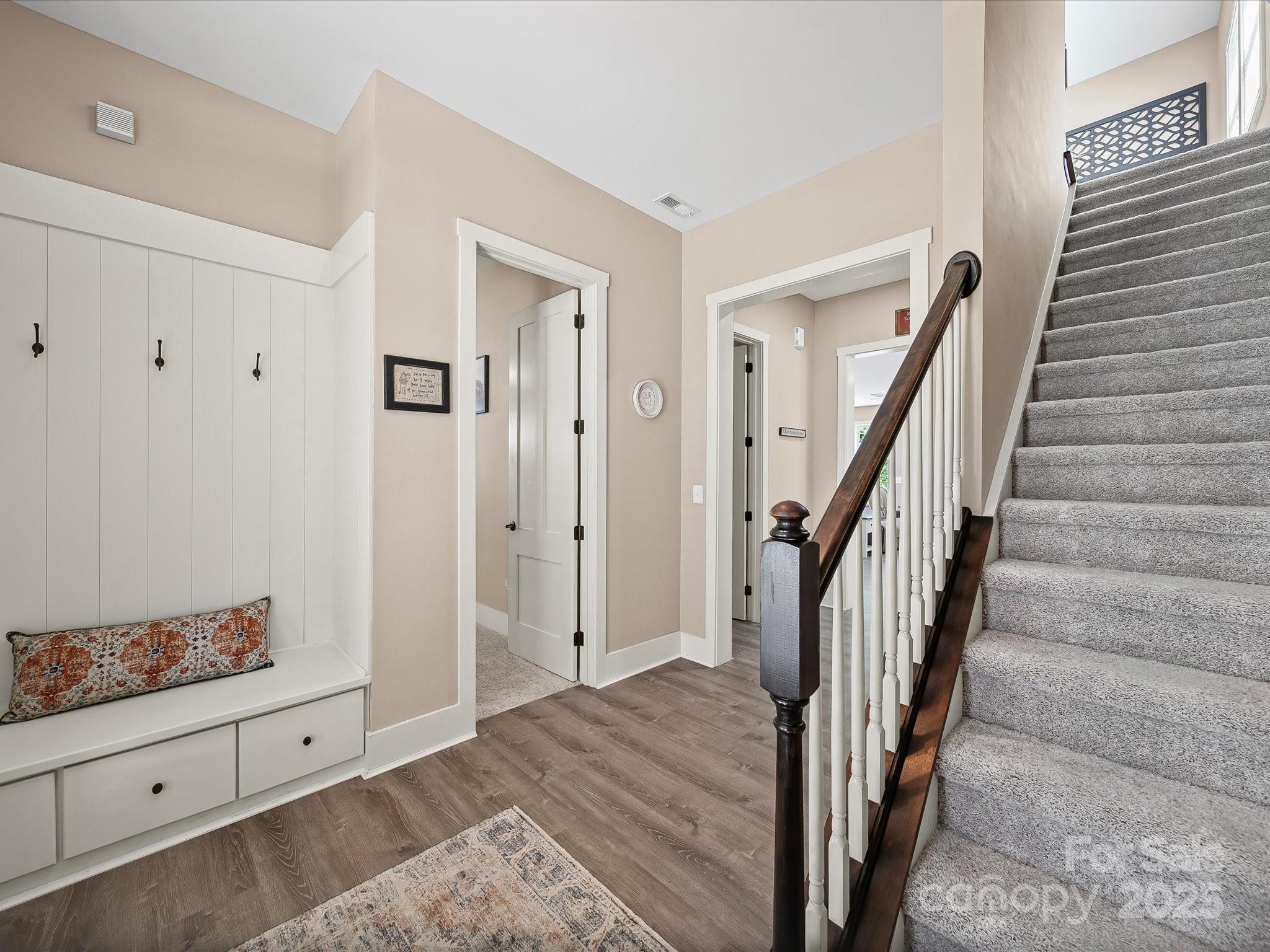 28117 Egrets Court Lancaster, SC 29720 - Photo 3 of 46 a view of a hallway to a livingroom with wooden floor and stairs