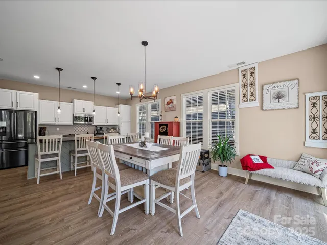 a kitchen with stainless steel appliances granite countertop a refrigerator a stove sink and cabinets