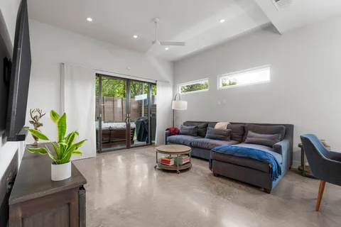a living room with furniture a rug and a chandelier