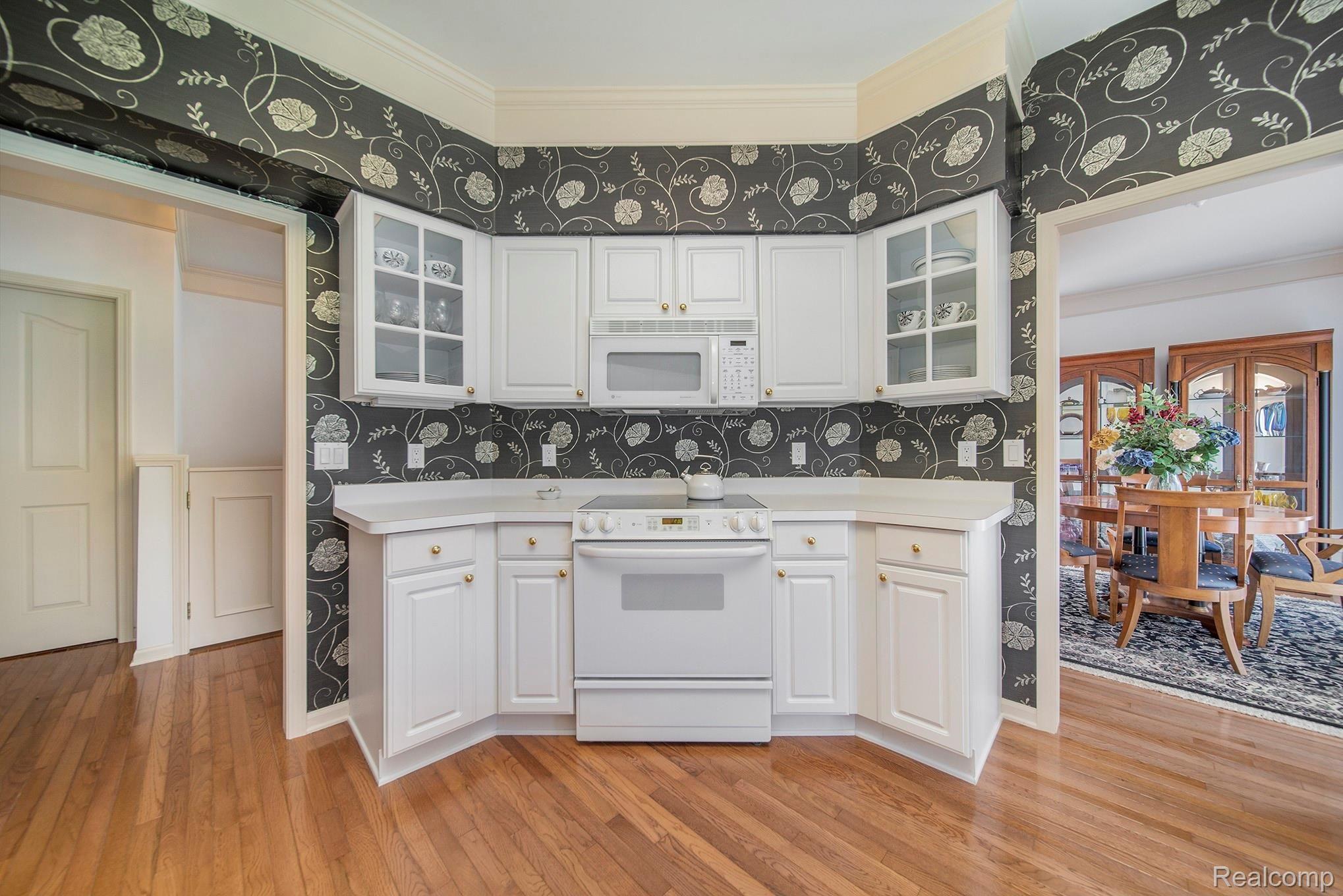 1379 Copper Circle, Unit 35 Rochester, MI 48306 - Photo 22 of 47 GLASS CABINET DOORS TO HIGHLIGHT YOURFAVORITES! LARGE OPENING TO DINING AREA.