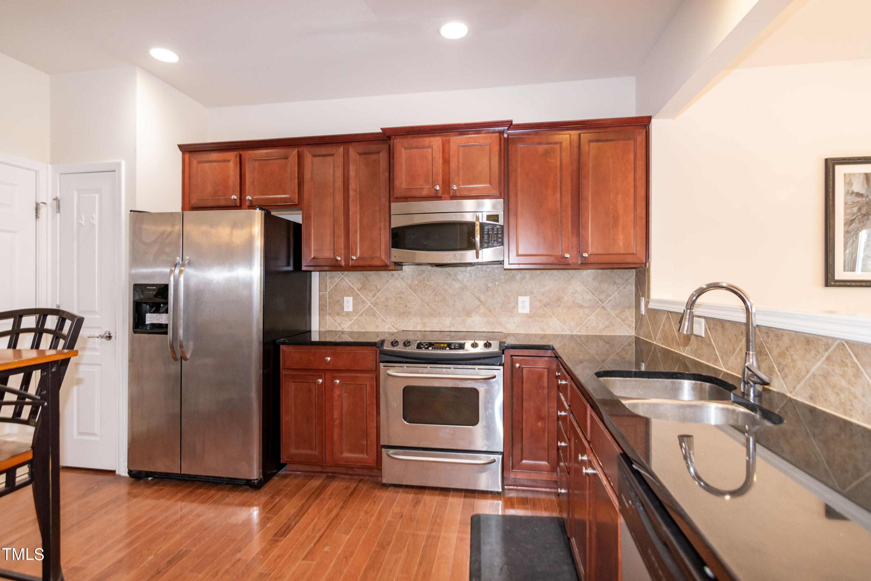 8621 Thunderwood Drive Raleigh, NC 27617 - Photo 14 of 35 a kitchen with a sink stove and refrigerator