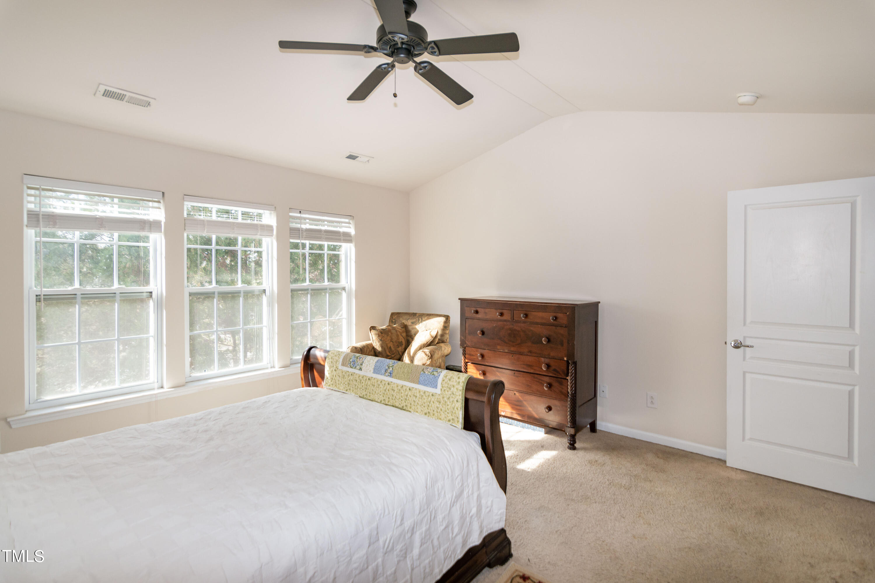 8621 Thunderwood Drive Raleigh, NC 27617 - Photo 17 of 35 a bedroom with a bed and a large window