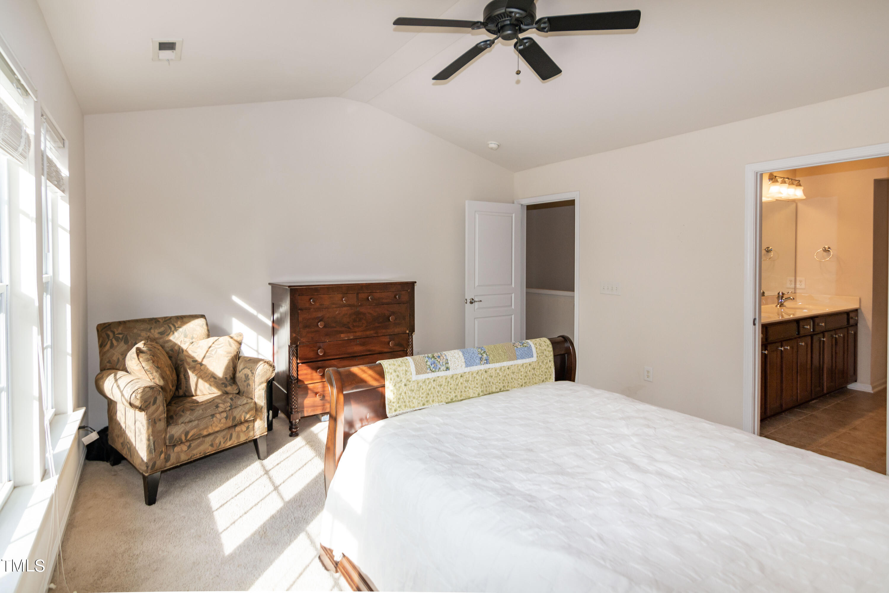 8621 Thunderwood Drive Raleigh, NC 27617 - Photo 18 of 35 a bedroom with a bed and ceiling fan