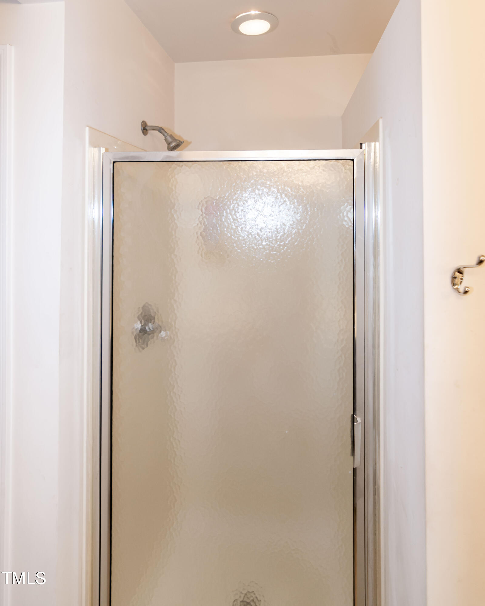 8621 Thunderwood Drive Raleigh, NC 27617 - Photo 22 of 35 a bathroom with a glass shower door