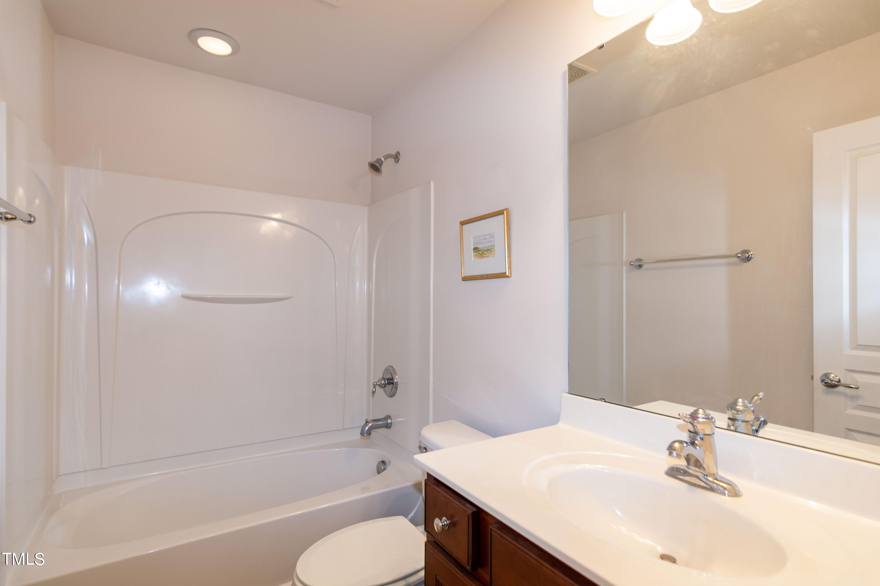 8621 Thunderwood Drive Raleigh, NC 27617 - Photo 27 of 35 a bathroom with a bathtub shower sink and a toilet