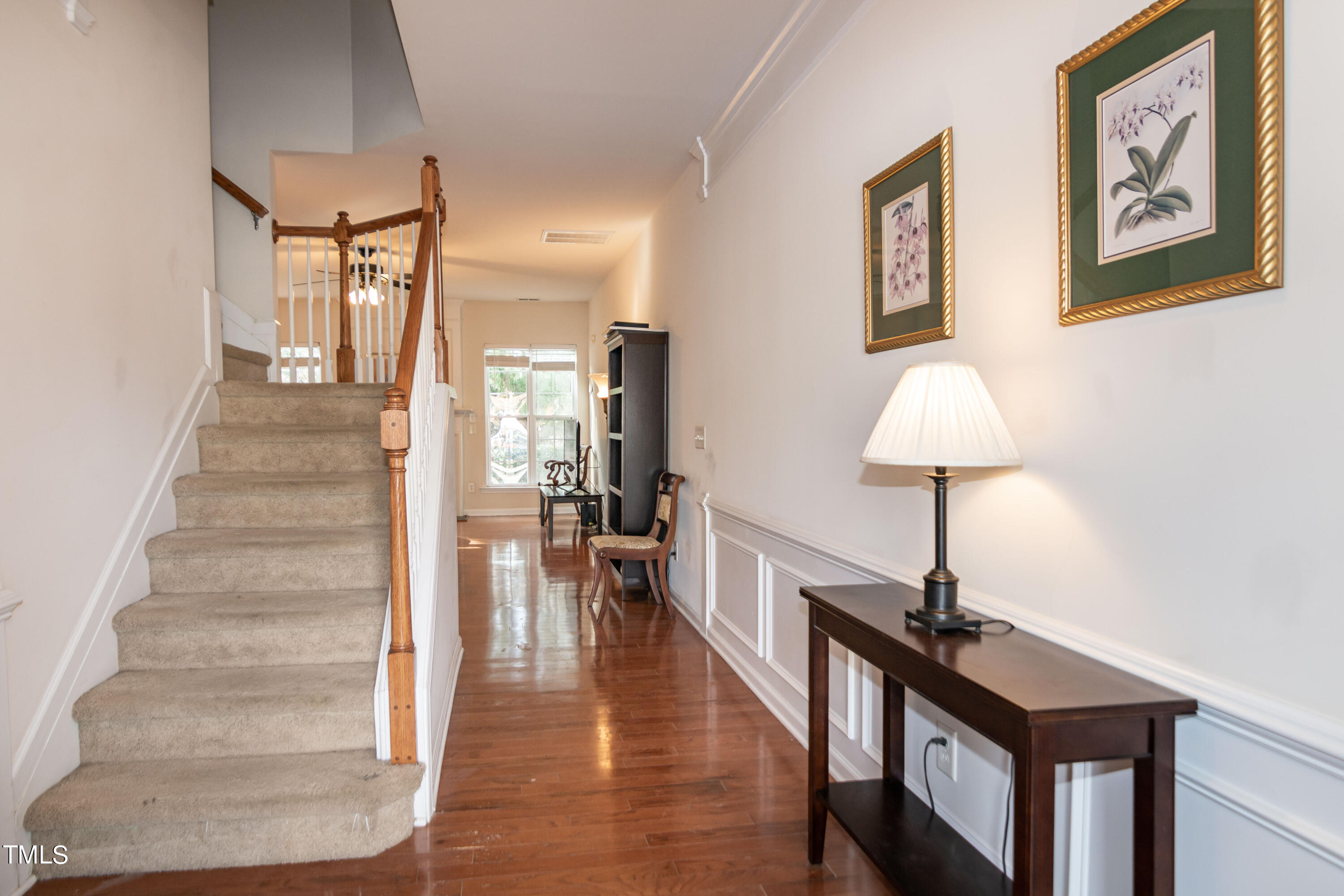8621 Thunderwood Drive Raleigh, NC 27617 - Photo 4 of 35 a view of a hallway with wooden floor and staircase