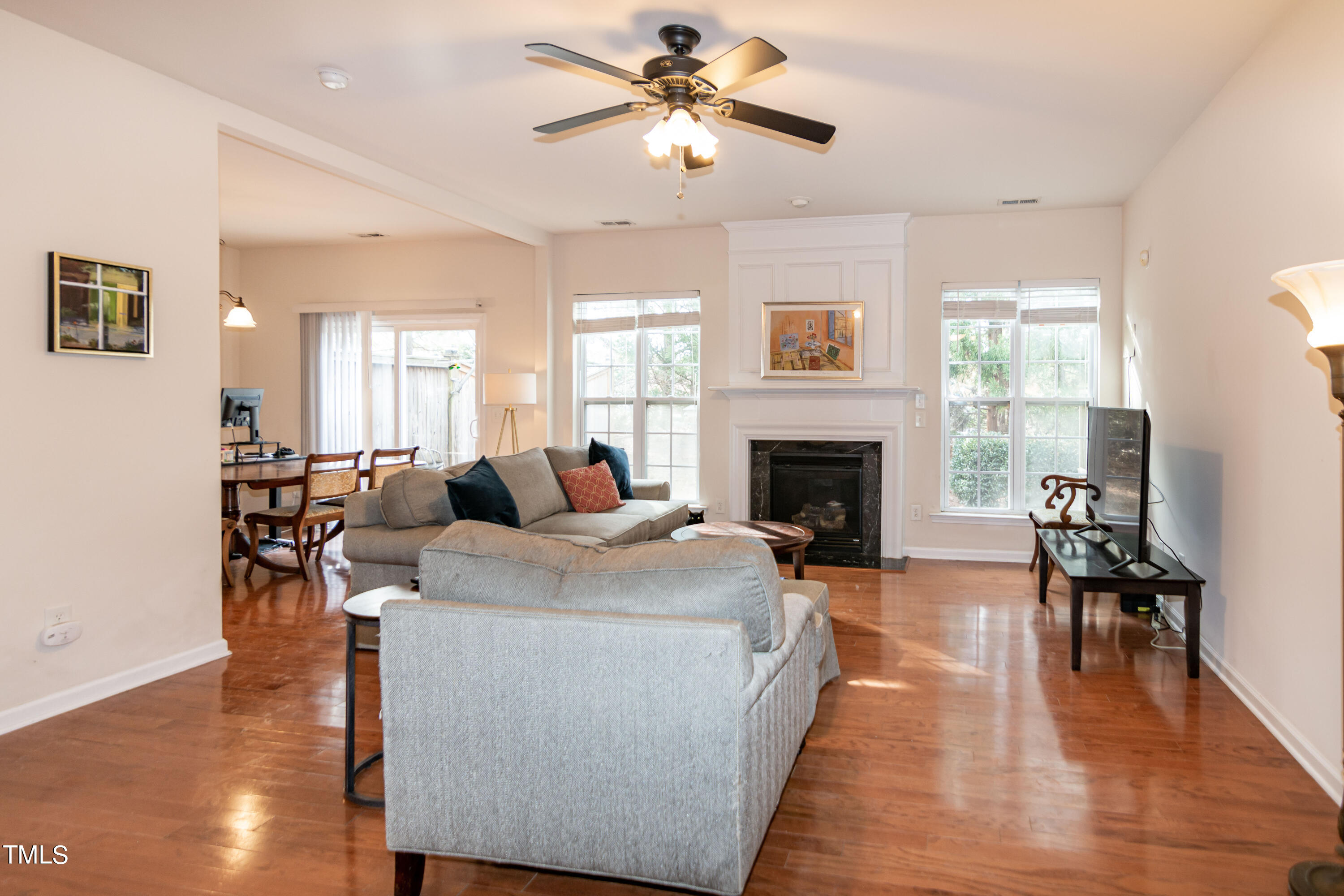 8621 Thunderwood Drive Raleigh, NC 27617 - Photo 5 of 35 a living room with furniture a fireplace and a flat screen tv