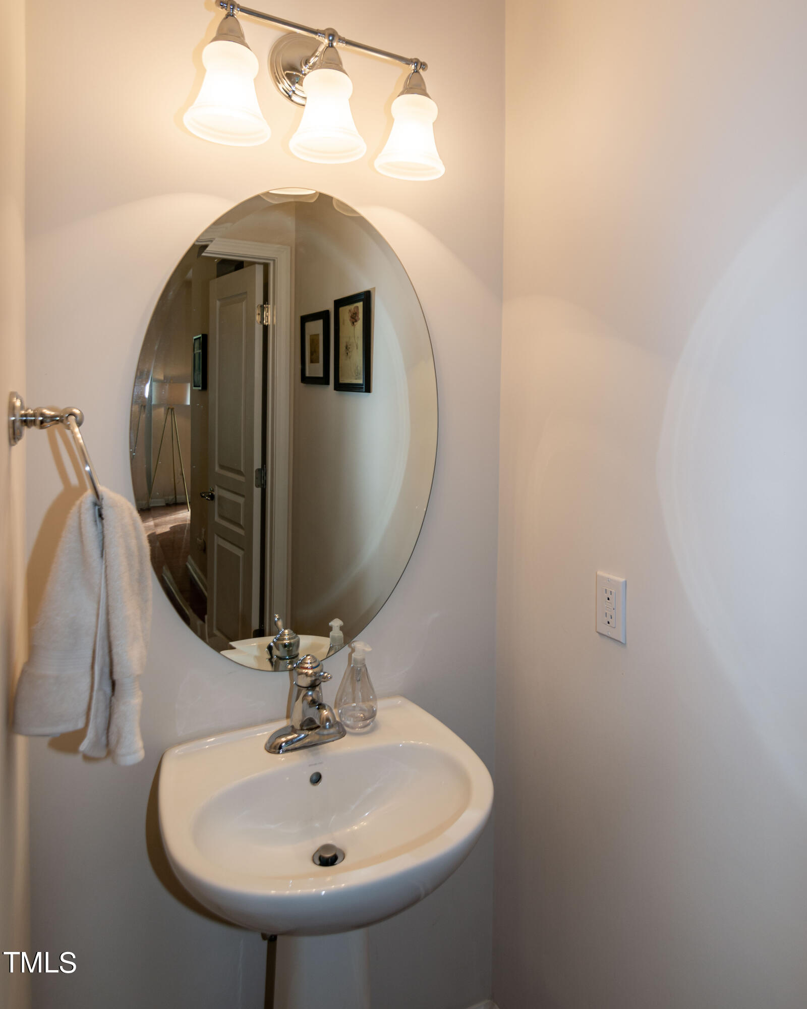 8621 Thunderwood Drive Raleigh, NC 27617 - Photo 9 of 35 a bathroom with a sink and mirror
