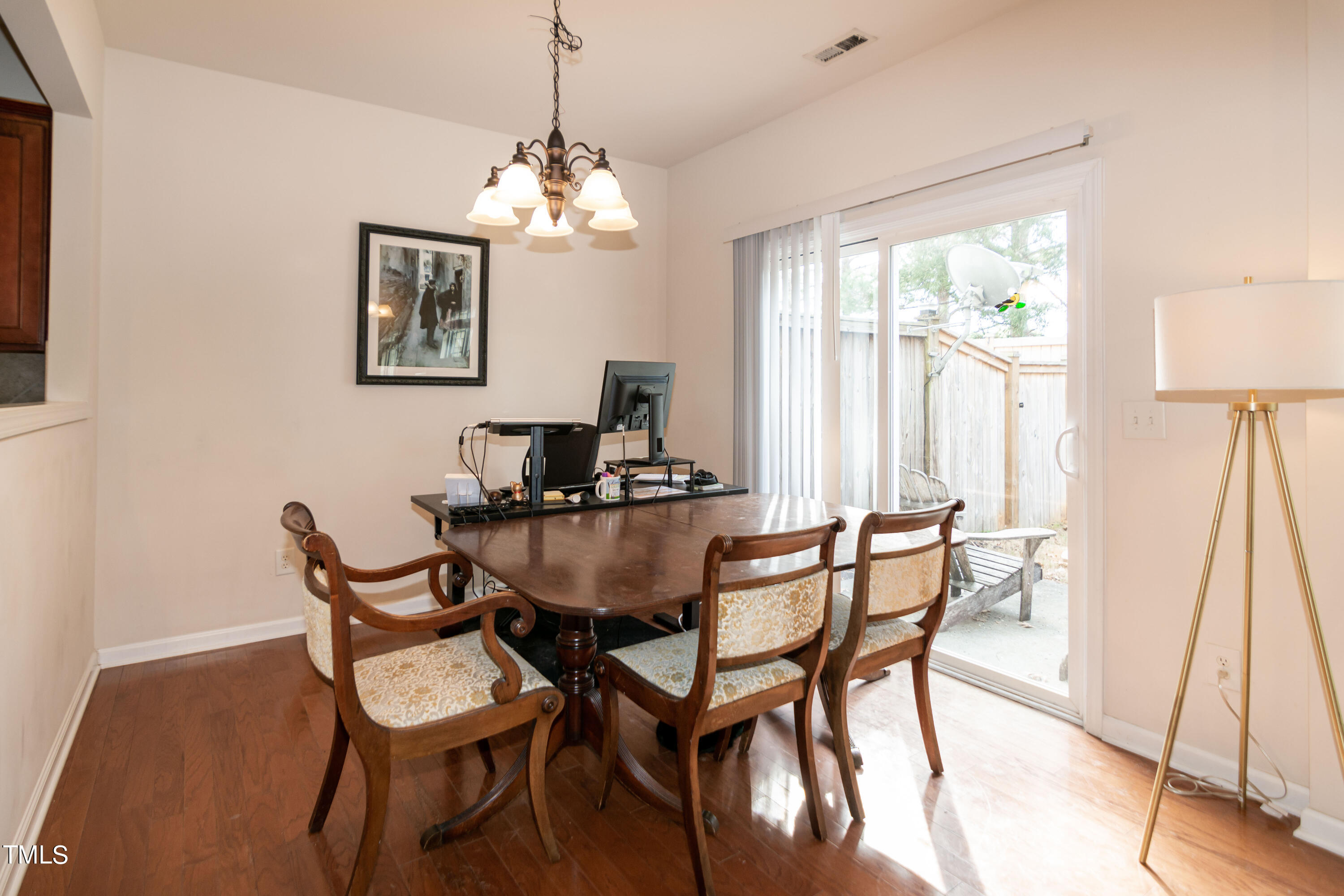 8621 Thunderwood Drive Raleigh, NC 27617 - Photo 10 of 35 a view of a dining room with furniture and a chandelier