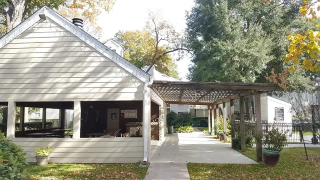 a view of a house with floor to ceiling windows and a basket ball poll
