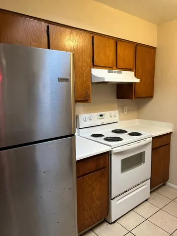a white refrigerator freezer sitting inside of a kitchen