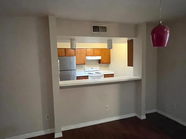 a kitchen with a sink cabinets and a window