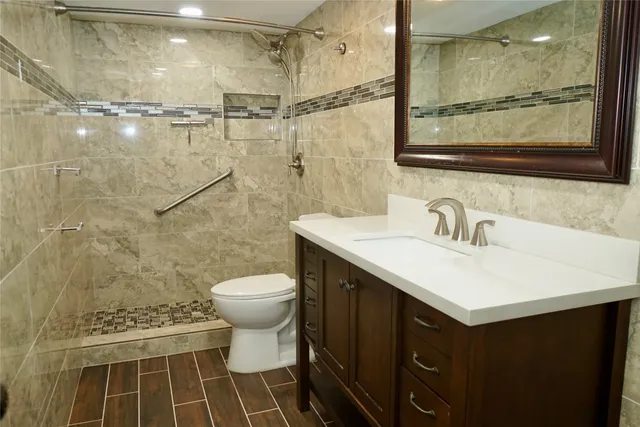 a bathroom with a sink toilet and shower