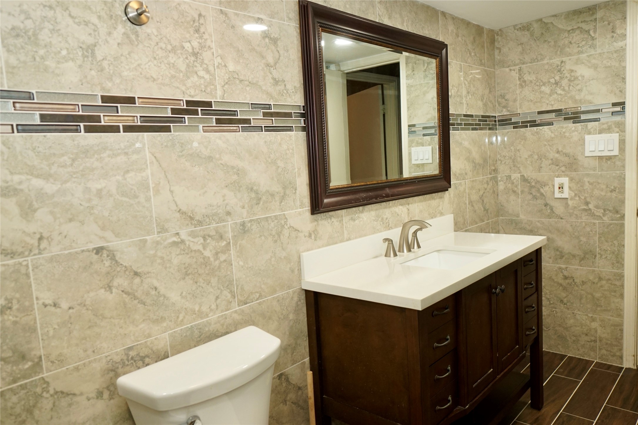 8275 Sands Point Drive, Unit 176 Houston, TX 77036 - Photo 13 of 31 a bathroom with a sink a toilet and mirror