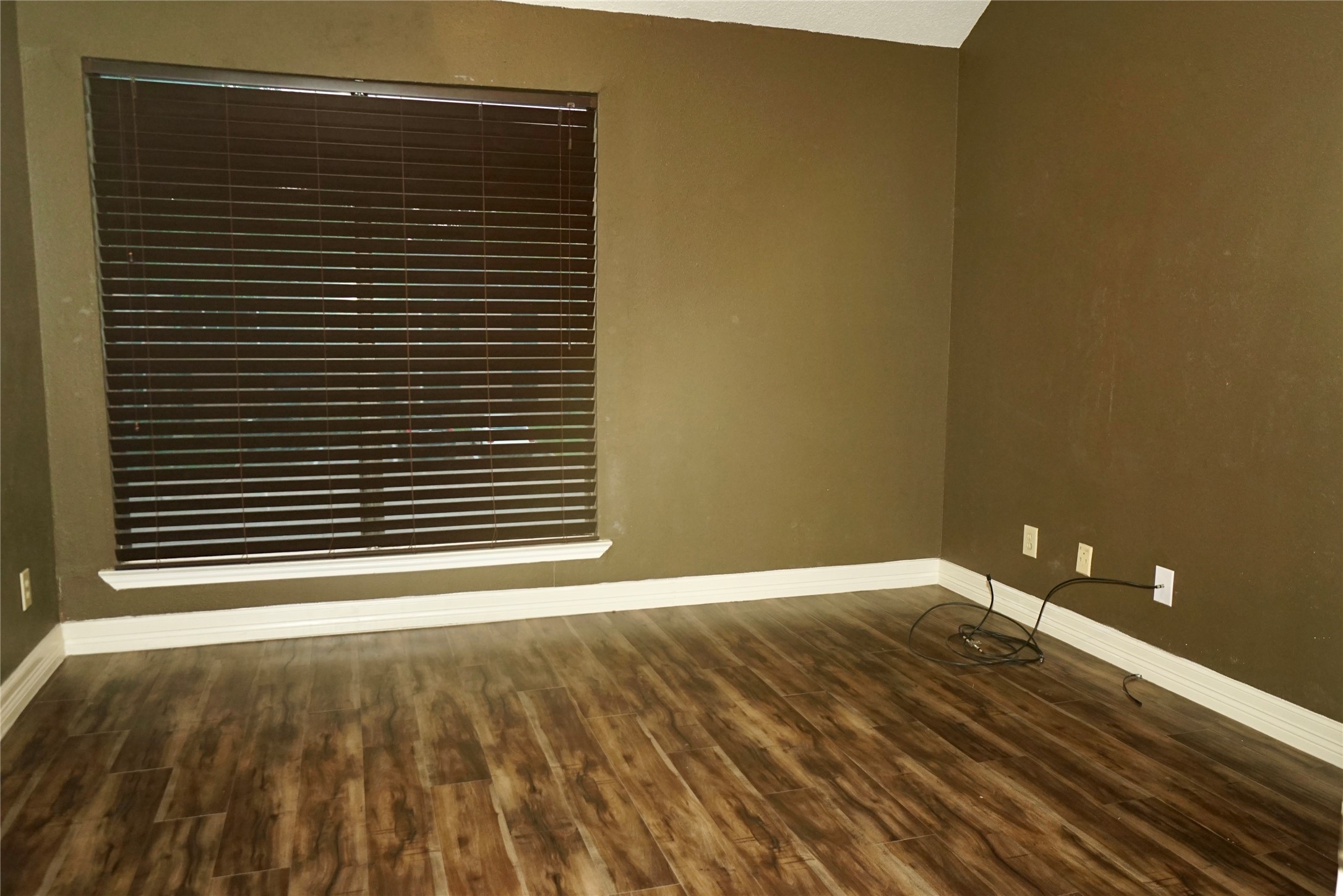 8275 Sands Point Drive, Unit 176 Houston, TX 77036 - Photo 15 of 31 a view of an empty room with wooden floor