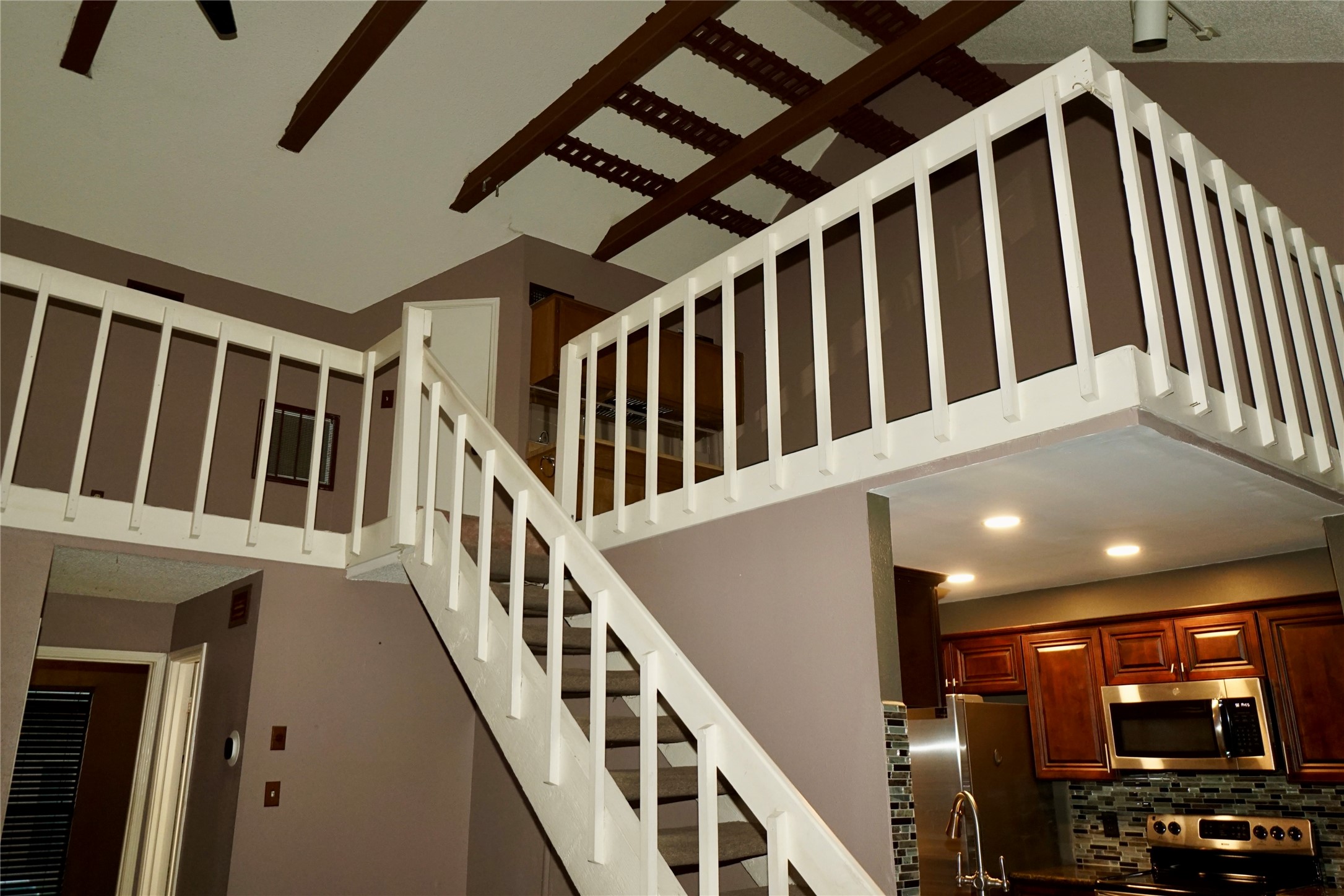 8275 Sands Point Drive, Unit 176 Houston, TX 77036 - Photo 19 of 31 a view of staircase with lots of frames on wall and a window