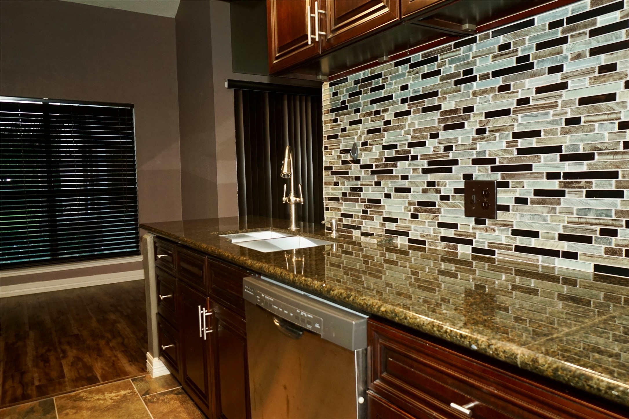 8275 Sands Point Drive, Unit 176 Houston, TX 77036 - Photo 6 of 31 a bathroom with a granite countertop sink and a black white checkered floor