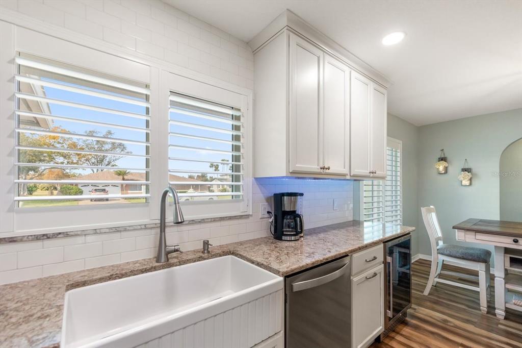 7133 Augusta Boulevard Seminole, FL 33777 - Photo 16 of 54 a kitchen with granite countertop a sink and a window