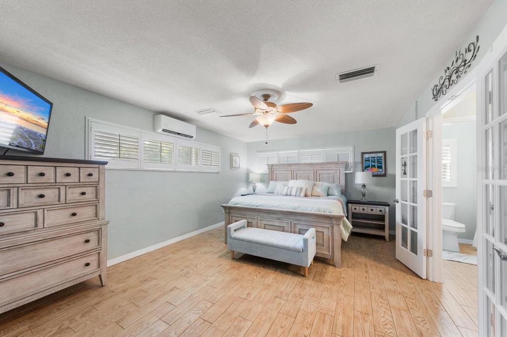 7133 Augusta Boulevard Seminole, FL 33777 - Photo 17 of 54 a bedroom with furniture and a flat screen tv