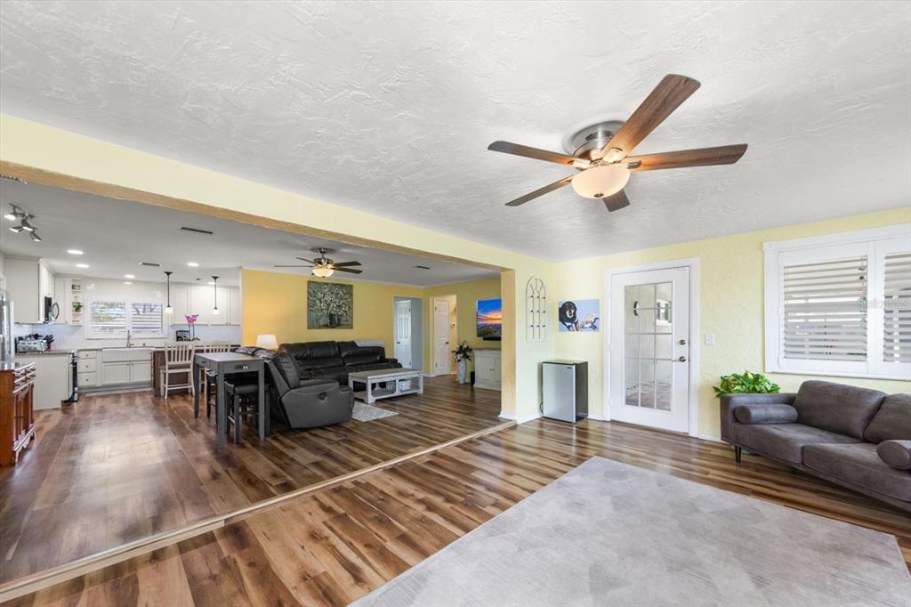 7133 Augusta Boulevard Seminole, FL 33777 - Photo 18 of 54 a living room with furniture a dining table and a fireplace