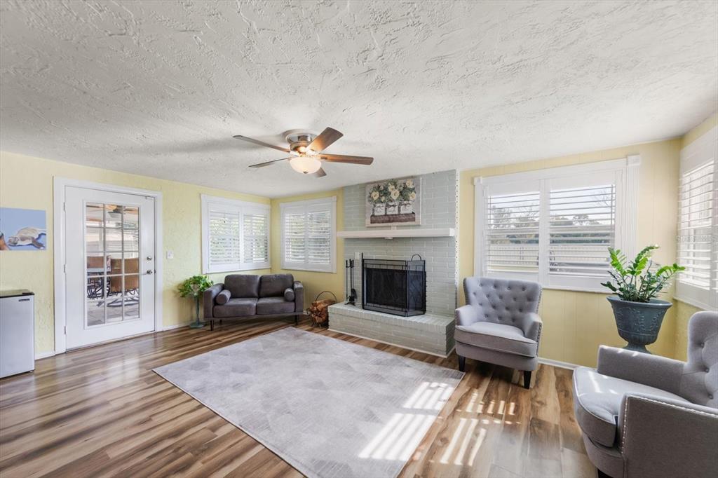 7133 Augusta Boulevard Seminole, FL 33777 - Photo 19 of 54 a living room with furniture and a fireplace