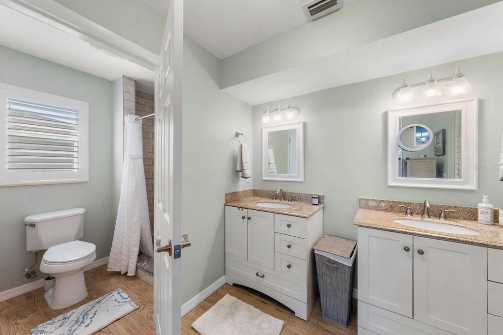 7133 Augusta Boulevard Seminole, FL 33777 - Photo 20 of 54 a bathroom with a toilet sink and mirror
