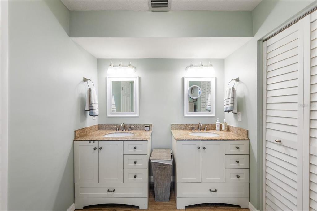 7133 Augusta Boulevard Seminole, FL 33777 - Photo 21 of 54 a bathroom with a double vanity sink mirror and