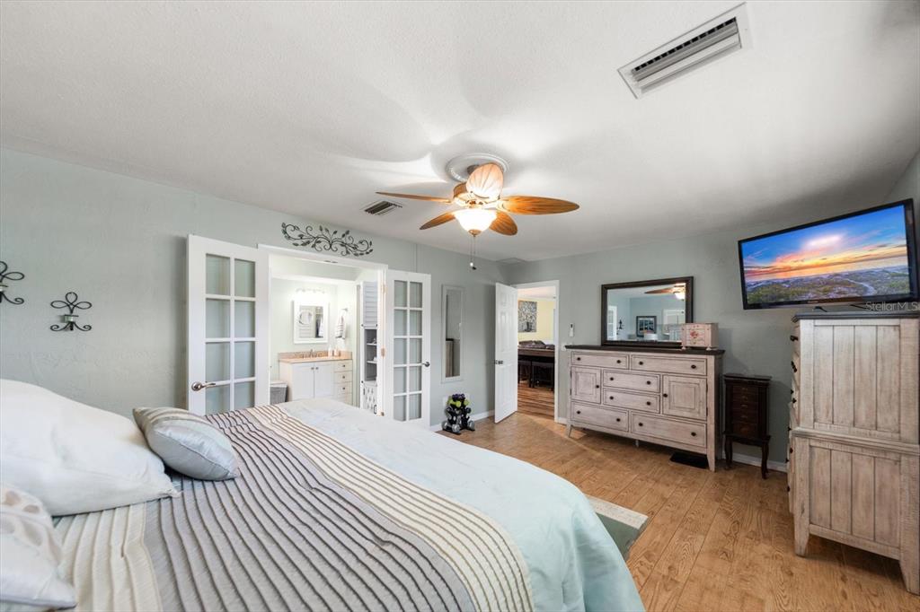 7133 Augusta Boulevard Seminole, FL 33777 - Photo 22 of 54 a bedroom with a bed and a chandelier