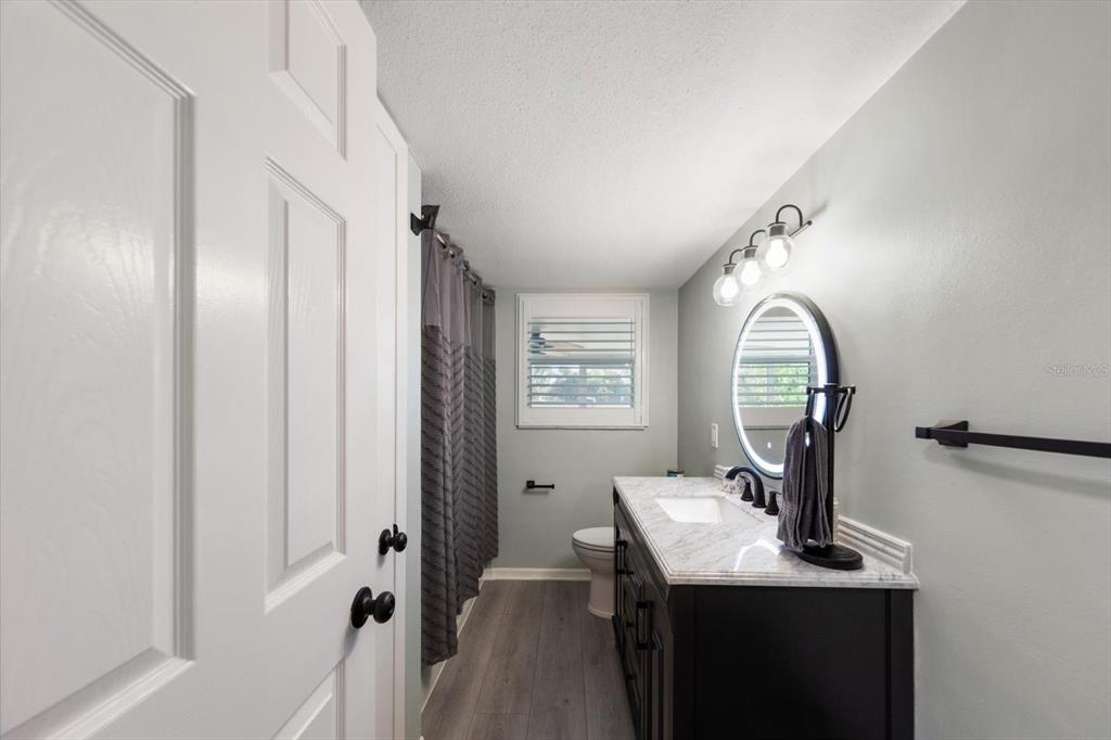 7133 Augusta Boulevard Seminole, FL 33777 - Photo 23 of 54 a view of a bathroom with a sink and mirror