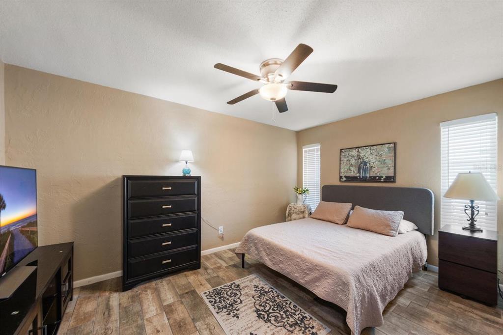 7133 Augusta Boulevard Seminole, FL 33777 - Photo 30 of 54 a bedroom with a bed and a chandelier