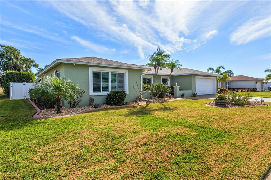 7133 Augusta Boulevard Seminole, FL 33777 - Photo 3 of 54 a front view of a house with garden