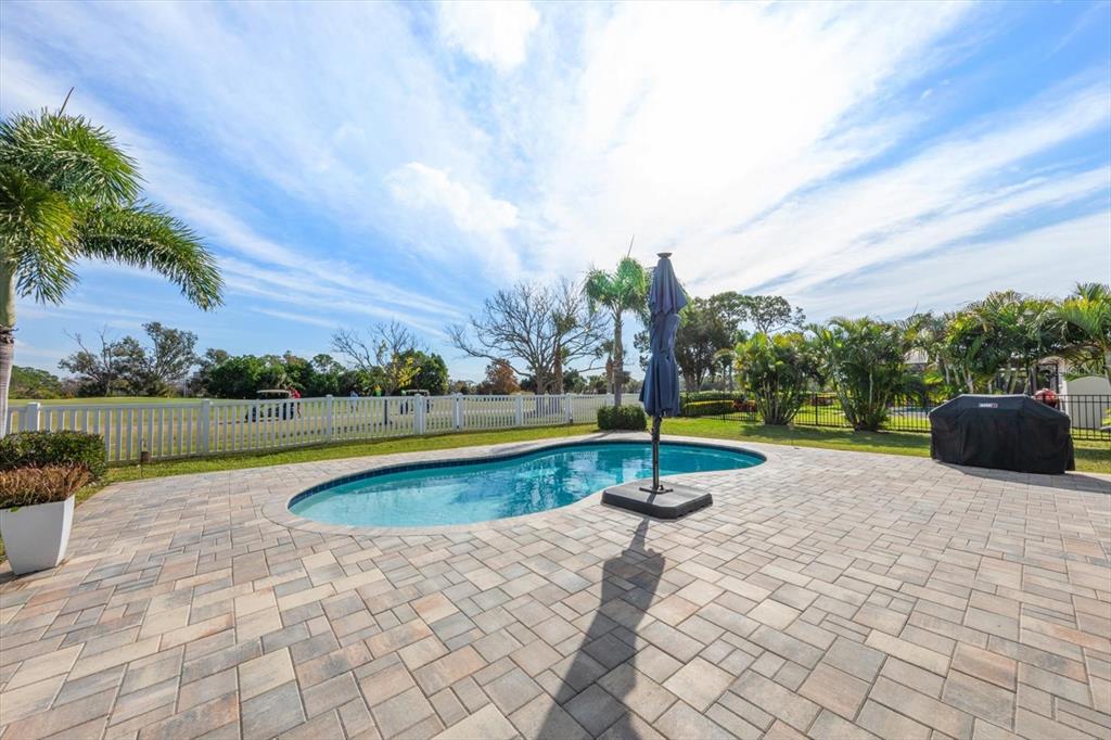 7133 Augusta Boulevard Seminole, FL 33777 - Photo 33 of 54 a view of swimming pool with a yard and palm trees