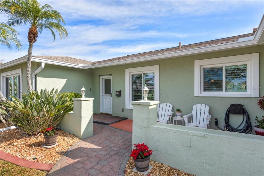 7133 Augusta Boulevard Seminole, FL 33777 - Photo 4 of 54 a front view of a house with garden