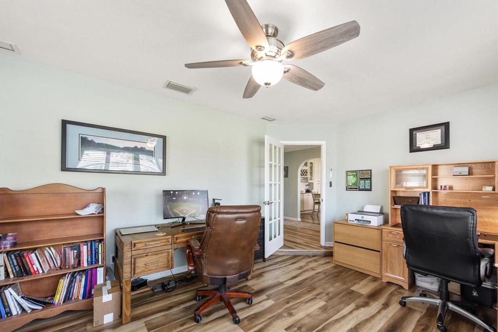 7133 Augusta Boulevard Seminole, FL 33777 - Photo 42 of 54 a view of a workspace with furniture and a bookshelf