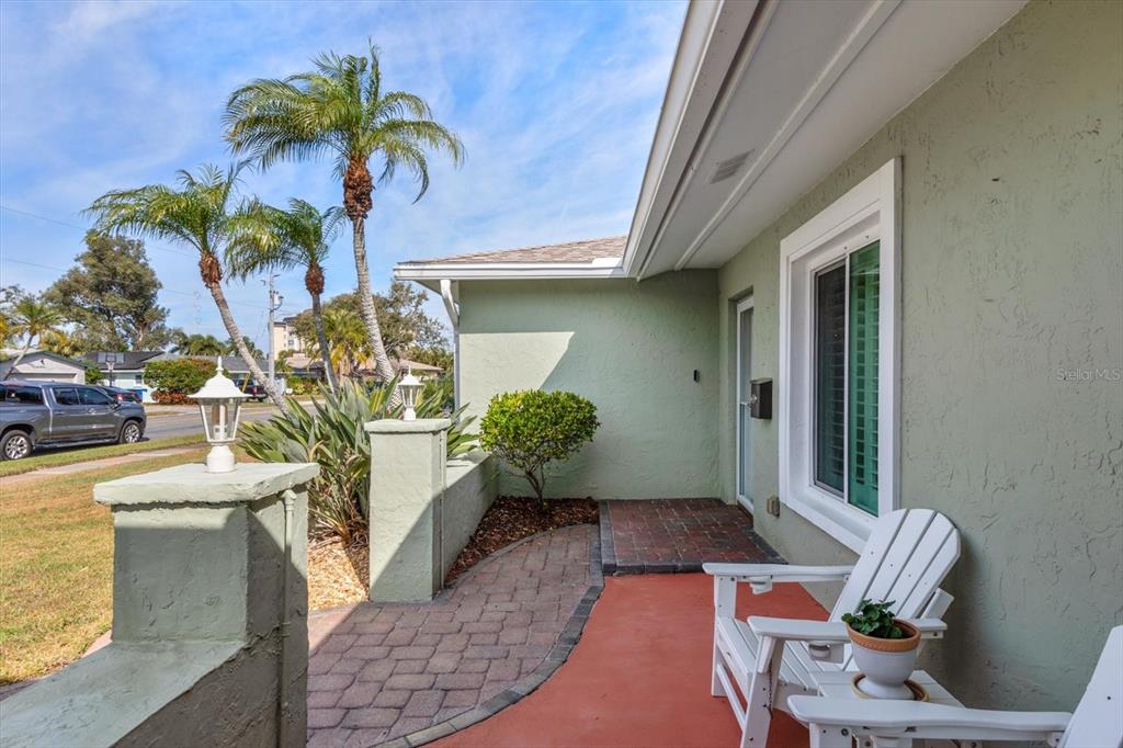 7133 Augusta Boulevard Seminole, FL 33777 - Photo 5 of 54 a vase with flowers sitting on a table in front of a door