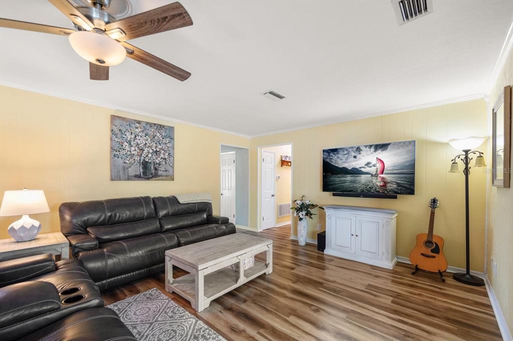 7133 Augusta Boulevard Seminole, FL 33777 - Photo 9 of 54 a living room with furniture and a flat screen tv