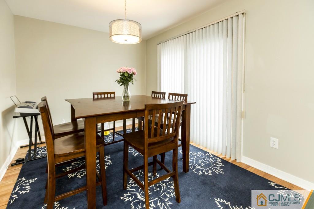 106 Normandy Road Colonia, NJ 07067 - Photo 11 of 25 a view of a dining room with furniture and wooden floor