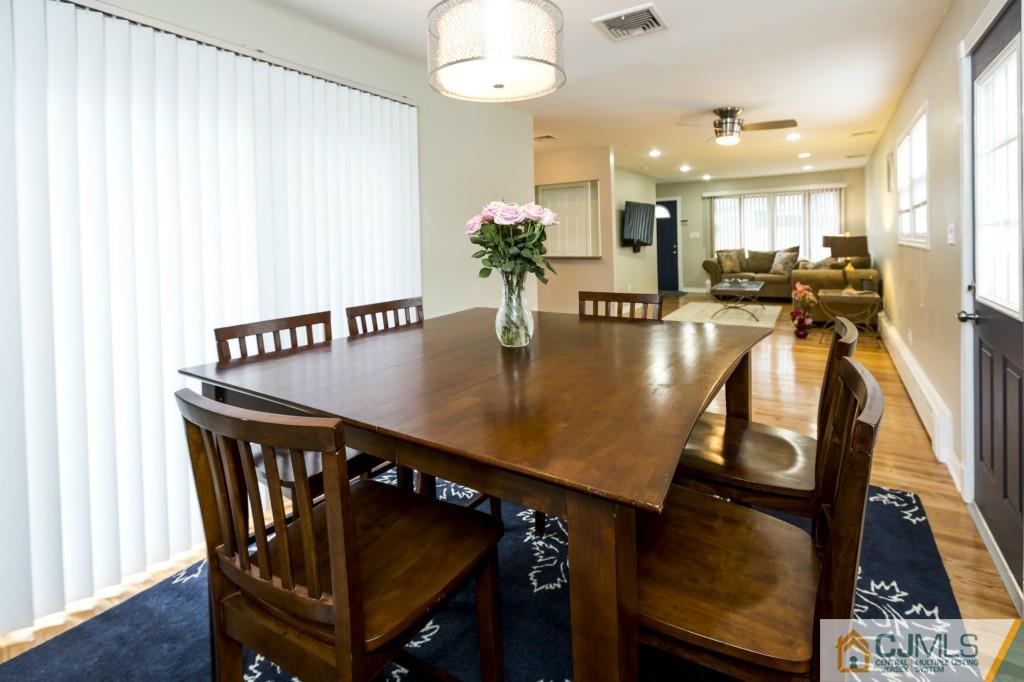 106 Normandy Road Colonia, NJ 07067 - Photo 12 of 25 a view of a dining room with furniture and wooden floor