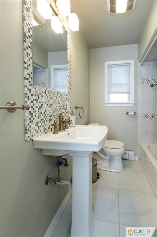 106 Normandy Road Colonia, NJ 07067 - Photo 14 of 25 a bathroom with a sink a toilet and mirror