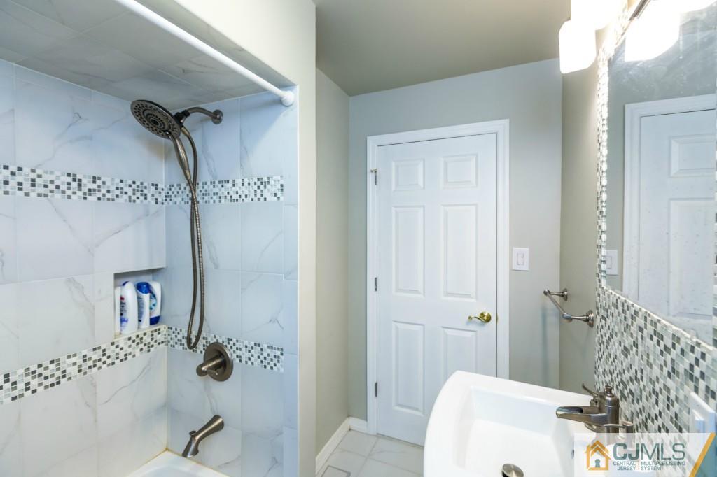 106 Normandy Road Colonia, NJ 07067 - Photo 15 of 25 a bathroom with a sink and shower