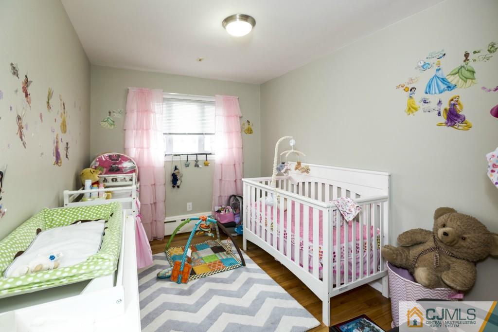 106 Normandy Road Colonia, NJ 07067 - Photo 18 of 25 a bedroom with a bed and a window