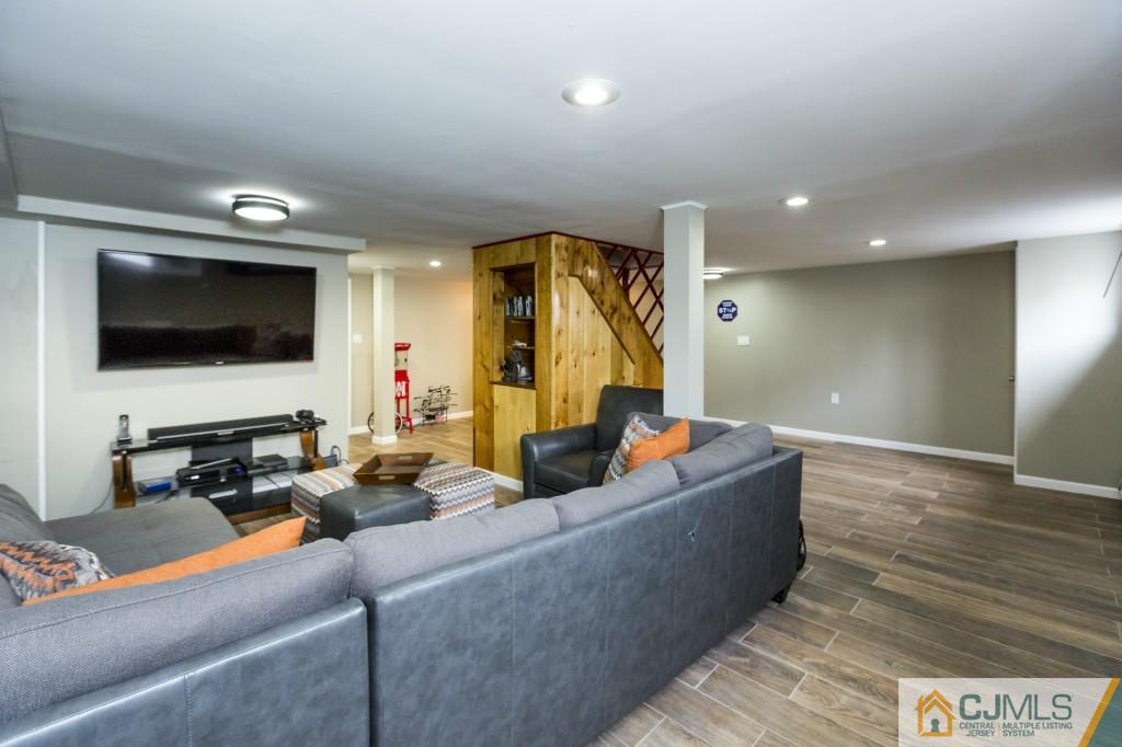 106 Normandy Road Colonia, NJ 07067 - Photo 20 of 25 a living room with furniture and a flat screen tv