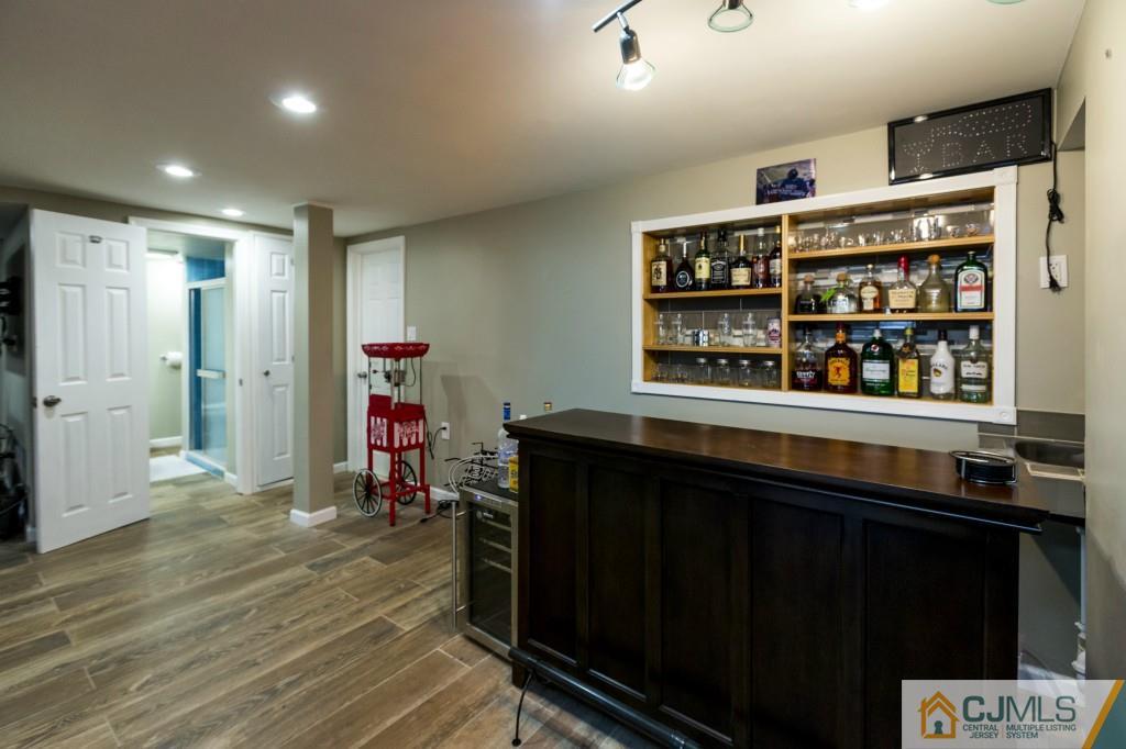 106 Normandy Road Colonia, NJ 07067 - Photo 21 of 25 a hallway with cabinets and wooden floor