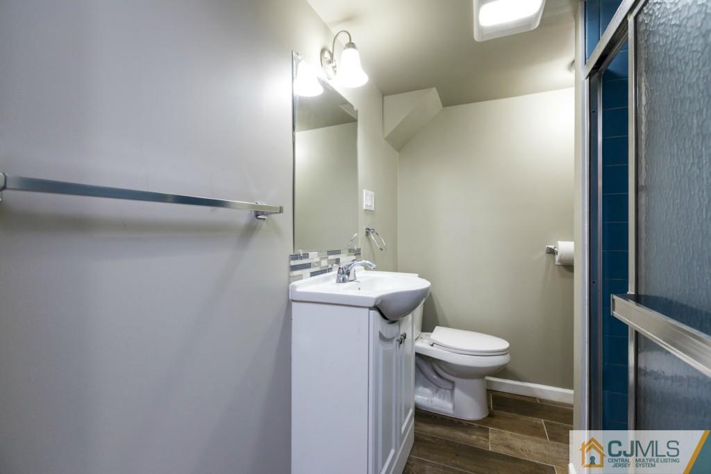 106 Normandy Road Colonia, NJ 07067 - Photo 22 of 25 a bathroom with a sink toilet and shower