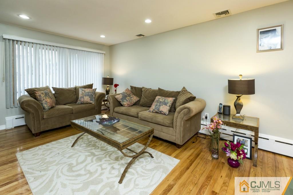 106 Normandy Road Colonia, NJ 07067 - Photo 5 of 25 a living room with furniture and wooden floor