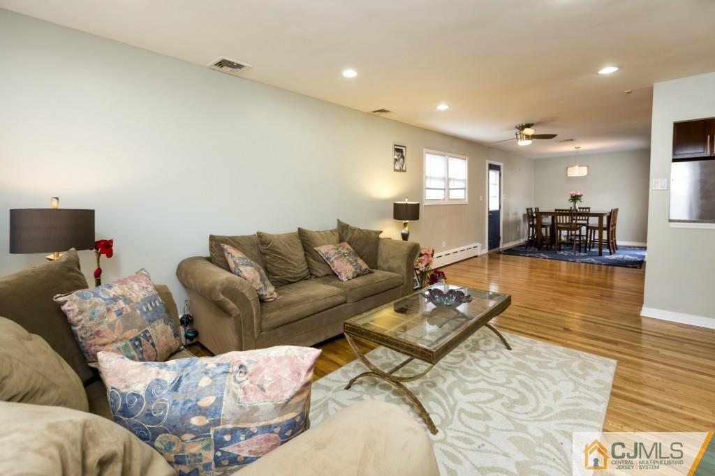 106 Normandy Road Colonia, NJ 07067 - Photo 6 of 25 a living room with furniture and wooden floor