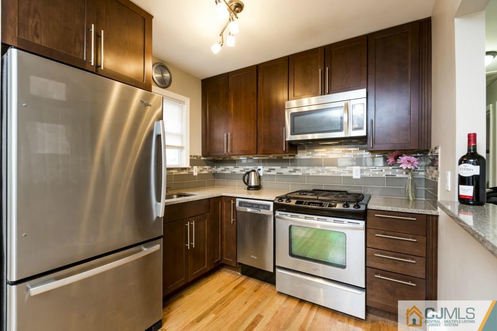 106 Normandy Road Colonia, NJ 07067 - Photo 8 of 25 a kitchen with a refrigerator stove and microwave