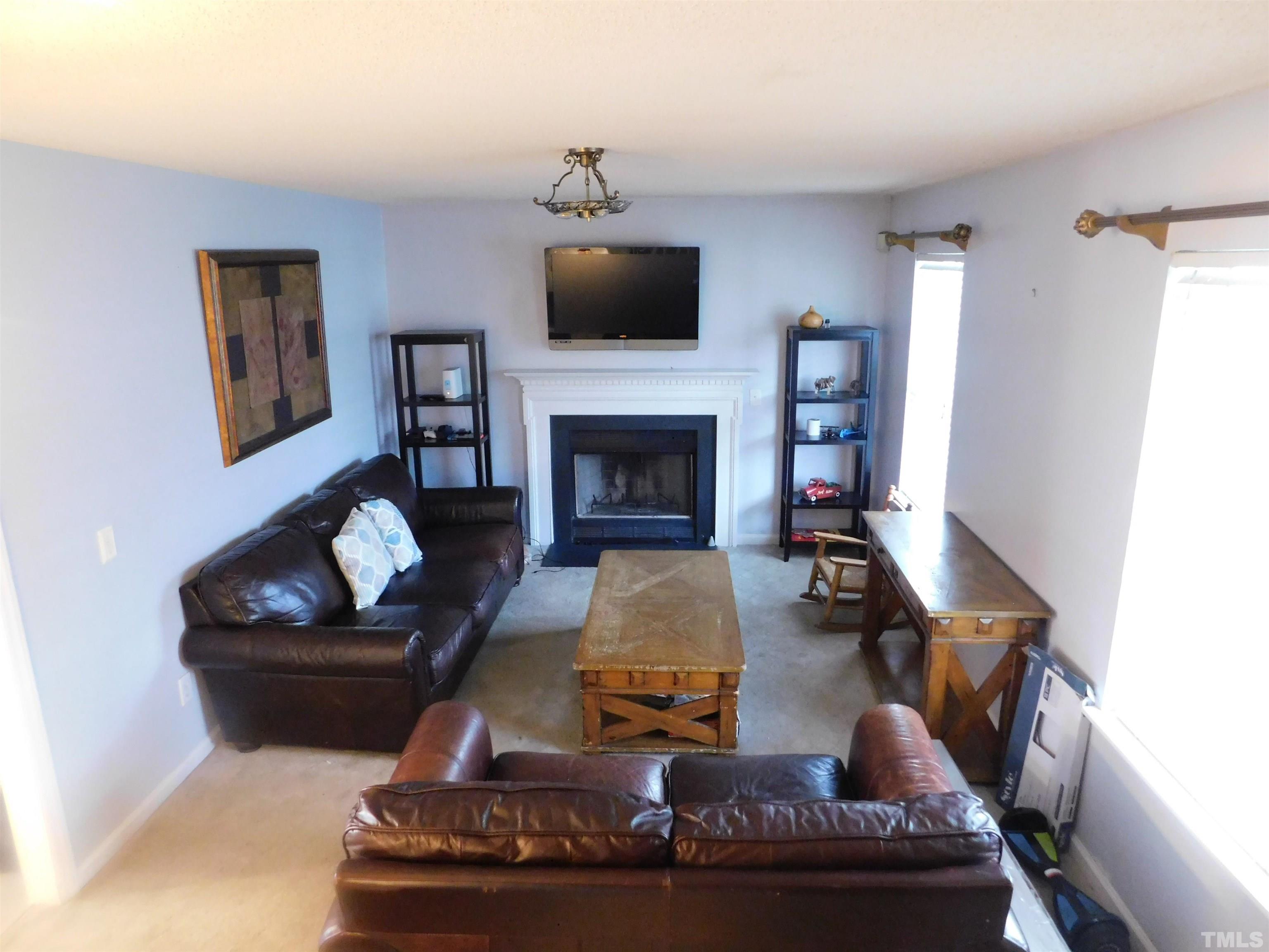 4017 Mardela Spring Drive Raleigh, NC 27616 - Photo 7 of 23 a living room with furniture and a fireplace