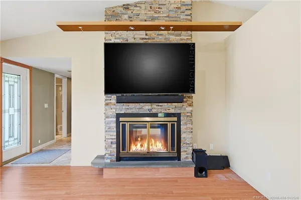 a living room with a fireplace and a wooden floor