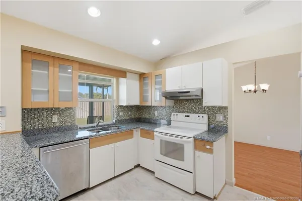 a kitchen with a stove top oven sink and cabinets